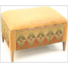 a foot stool with an upholstered design on the top and bottom, sitting in front of a white background