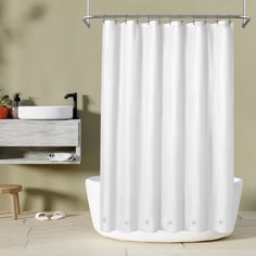 a white shower curtain in a bathroom