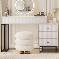 a white dressing table with a round mirror above it