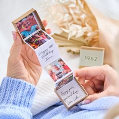 a woman holding an open box with pictures on it and the words happy birthday inside