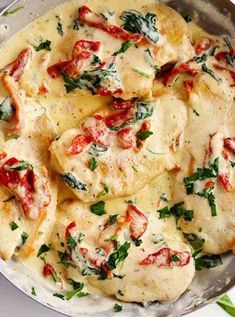 a pan filled with ravioli covered in cheese and spinach