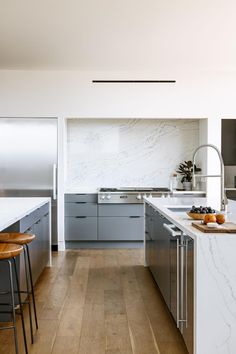 the kitchen is clean and ready to be used for cooking or eating, with marble countertops and stainless steel appliances