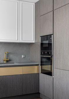 a kitchen with an oven, sink and cabinets in grey and yellow colors on the walls