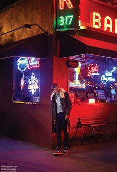 a person standing on a skateboard in front of a bar with neon signs and lights