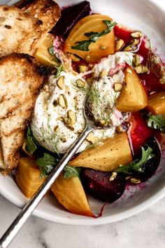 a white bowl filled with different types of food on top of a marble countertop