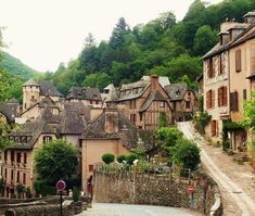 an old european village with cobblestone roads and stone buildings on the hillside side