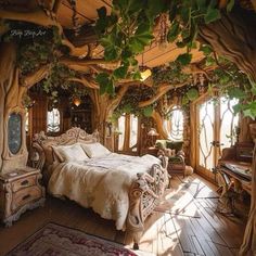 a bed sitting under a lush green canopy in a bedroom