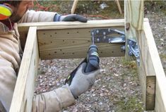 a man working with tools in a wooden box