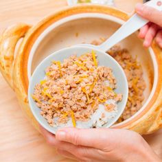 a person holding a bowl with food in it