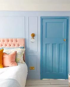 a bedroom with blue doors and pink headboard