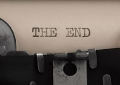 an old fashioned typewriter with the word the end printed on it's paper