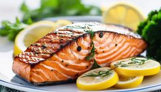 salmon with lemons and herbs on a plate