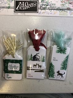 three packaged gift bags with tags attached to them