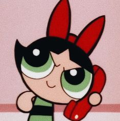 the powerpuff girl character is holding a red object in her hand and looking at the camera