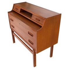 a wooden desk with two drawers and a shelf on one side, against a white background