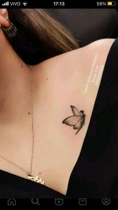 a woman with a butterfly tattoo on her chest