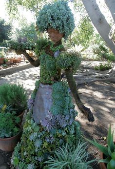 a statue made out of succulents and plants