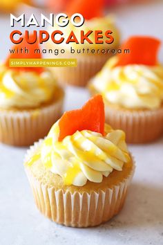 several cupcakes with orange and white frosting on them sitting on a table