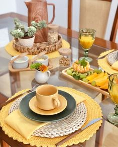 a glass table topped with plates and cups filled with food