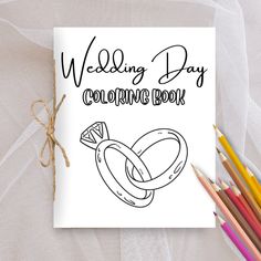 the wedding day coloring book is next to colored pencils