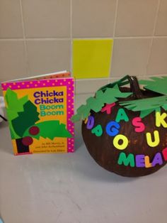 a child's book is next to a decorated pumpkin