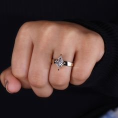 a woman's hand with a diamond ring on it