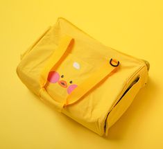 a yellow bag with a pig face on it