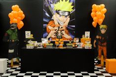 a table topped with balloons and naruto figurines on top of a checkered floor