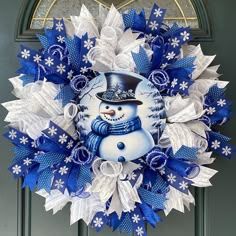 a blue and white wreath with a snowman on it