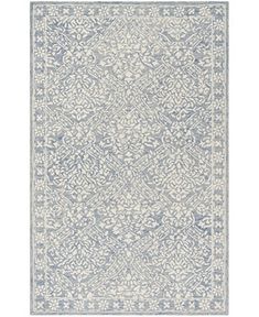 a blue and white rug with an intricate design on the bottom, in front of a white background