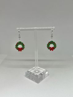 Hand beaded Christmas wreath earrings. Reinforced with clear resin to prevent curling. Beaded Christmas Wreath, Christmas Wreath Earrings, Wreath Earrings, Holiday Wreath, Clear Resin, Christmas Jewelry, Holiday Wreaths, Wedding Basket, Hand Beading