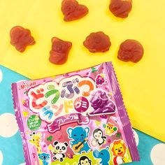 gummy bears are sitting on top of a polka dot table cloth next to some candy