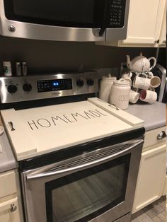 a stove top oven sitting inside of a kitchen next to a microwave and toaster oven