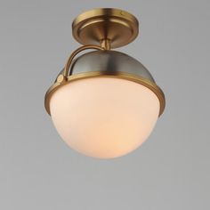 a ceiling light with a white glass shade