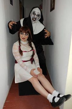 two people dressed up as the bride and groom sitting on a bench in a hallway