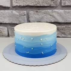 a blue and white cake sitting on top of a table