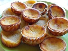 a green plate topped with mini pies on top of a table