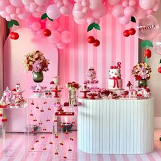 a pink and white dessert table with balloons