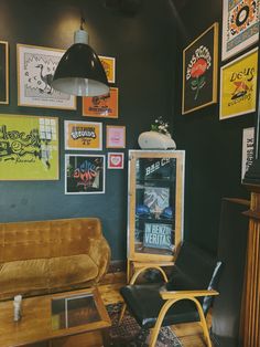 a living room filled with furniture and pictures on the wall