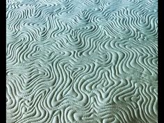 an abstract pattern is shown on the surface of this bedding set, which has been made up to look like waves