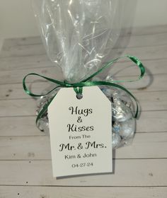 wedding favors wrapped in cellophane and tied with green ribbon