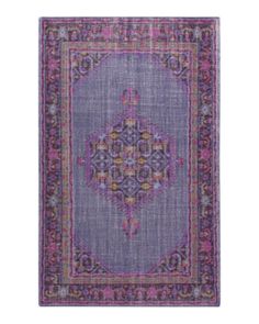 a purple rug with an ornate design on the front and back side, in various colors