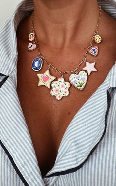 a close up of a person wearing a shirt and some necklaces on their chest