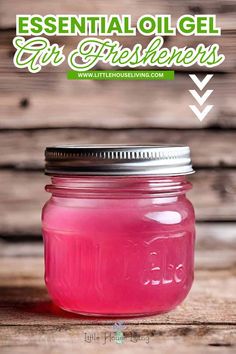 a mason jar filled with pink liquid sitting on top of a wooden table