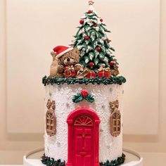 a white and red christmas cake with teddy bears on top