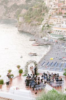 an outdoor wedding ceremony overlooking the ocean in positi