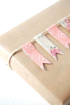 a brown box with pink and white polka dot bunting on the side, sitting on top of a table