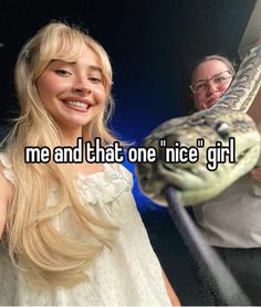 a girl holding a snake in front of her face with the caption me and that one nice girl