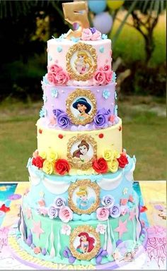 a multi - tiered cake is decorated with princesses and other things on it