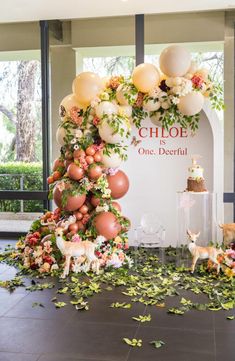 a table topped with balloons and flowers next to a sign that says glob is one beautiful